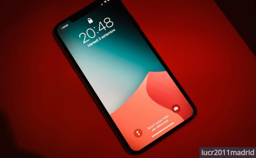 a close up of a cell phone on a red surface