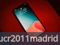a close up of a cell phone on a red surface